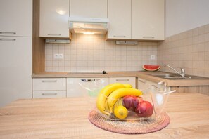 Fresh fruit and modern amenities await in this kitchen.