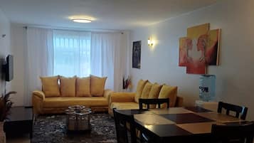 Design Apartment | Living area | 24-inch Smart TV with digital channels