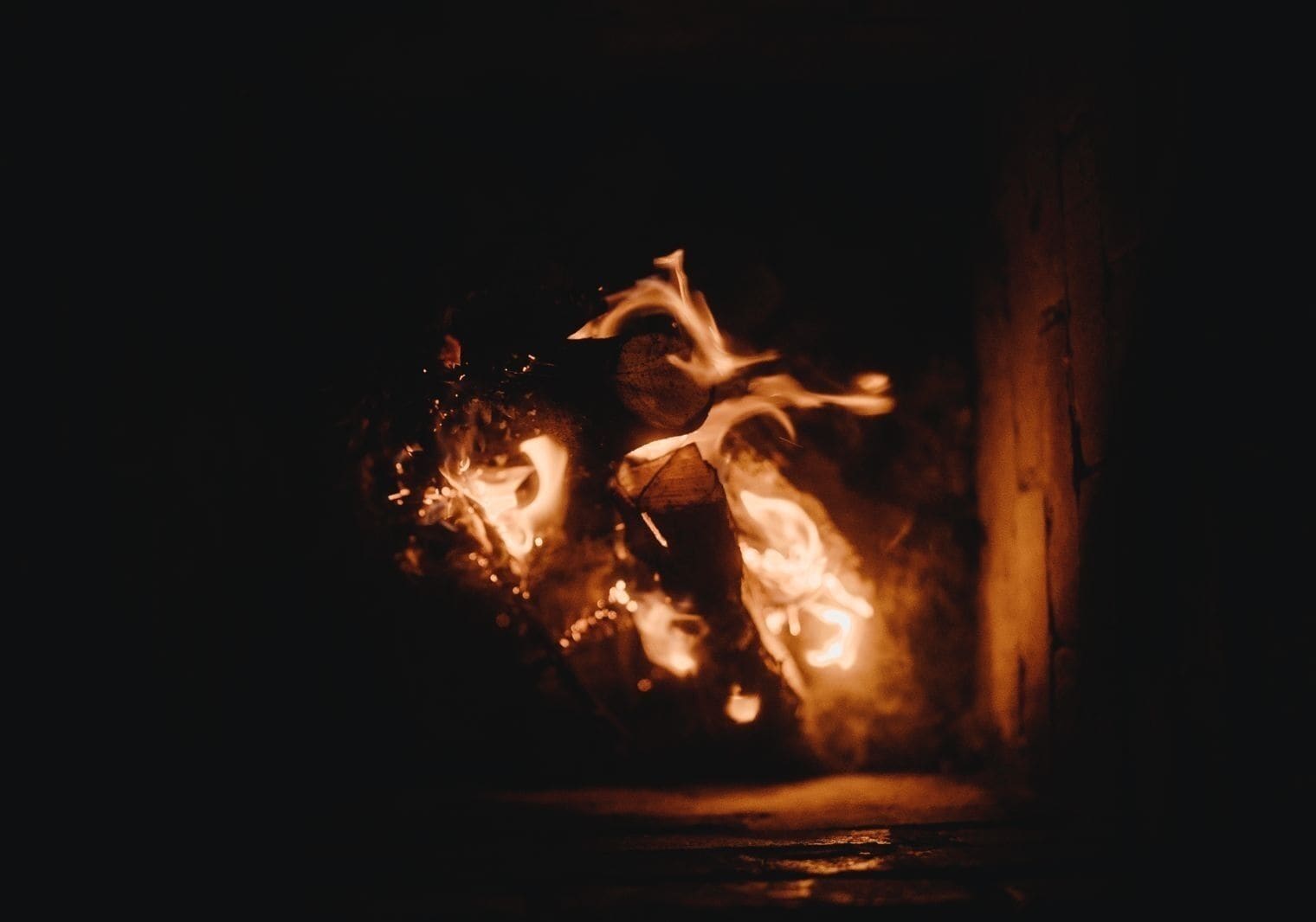 A close-up of a fire burning in a fireplace.