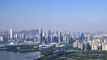 A cityscape with a river, high-rise buildings, and a stadium.