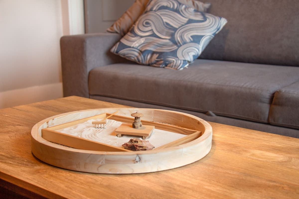 A wooden tray with a central wooden structure on a wooden table.