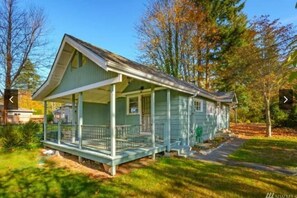 A single-story house with a porch, a front yard, and a driveway.