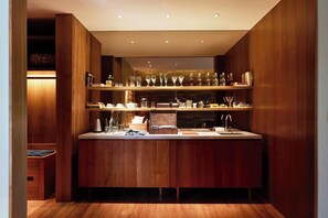 A modern kitchen with wooden cabinetry, a countertop, and a built-in sink.