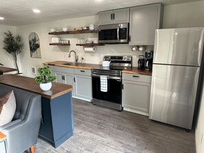 Fridge, coffee/tea maker, cookware/dishes/utensils