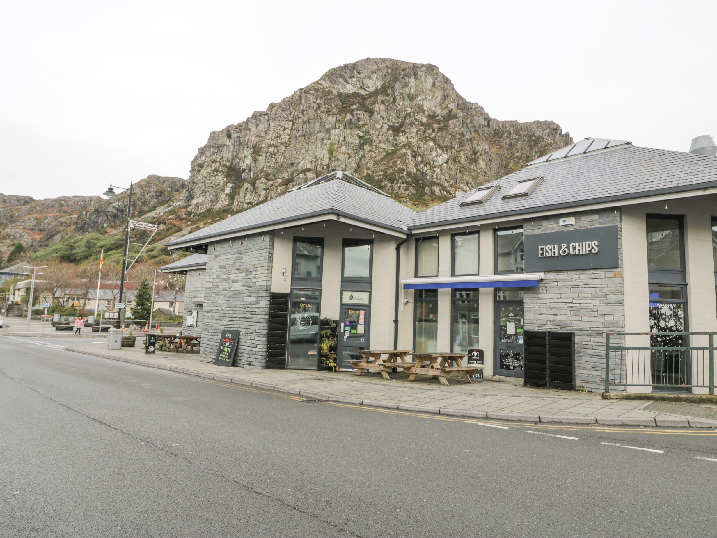 A restaurant with a stone facade and a sign reading "Fish & Chips".