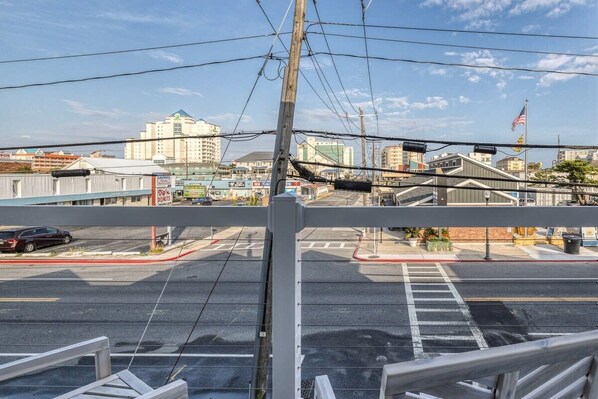 A street view with a parking lot, buildings, and a flag.