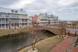 A waterfront property with a bridge, multiple-story buildings, and a river.