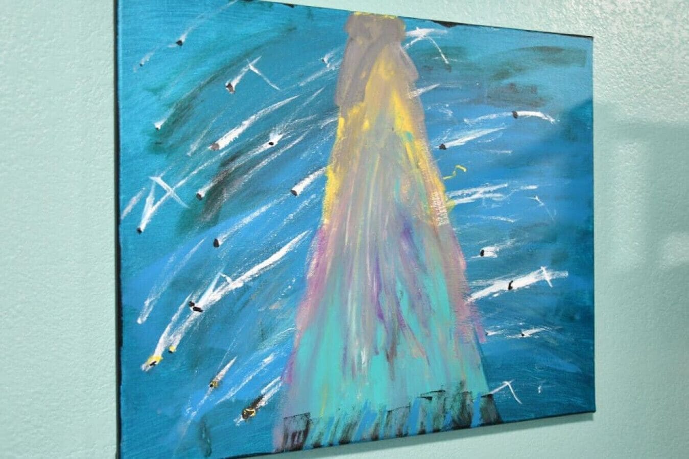 A painting with abstract shapes and lines on a wall.