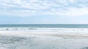 A beach with a clear sky and calm sea. - Coastal Retreat at Carolina Winds #2 + Pool (Myrtle Beach)