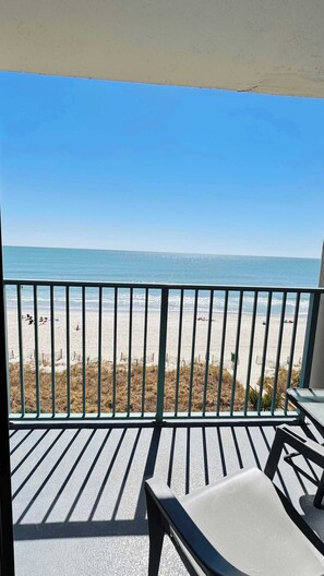 A balcony with a view of a beach. - Sand Dunes ocean front condo (Myrtle Beach)