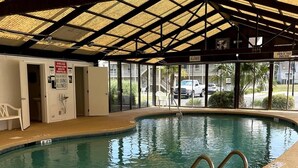 An indoor swimming pool with a covered roof, clear signage, and a lifeguard station. - LR1 Bay Tree 1 bedroom condo with pool (Little River)