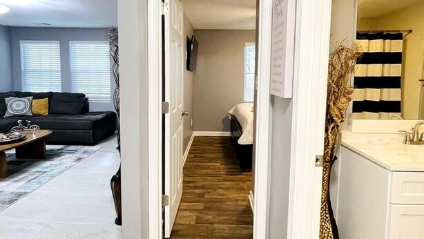 A modern apartment with a living room, a hallway leading to a bedroom, and a bathroom. - AW3 Stay close to the beach (Myrtle Beach)