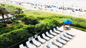 A beach with sun loungers and a sign indicating no lifeguard on duty. - BLUE WATER RESORT#12, Ocean view beautiful condo (Myrtle Beach)