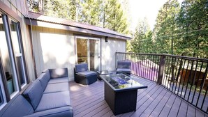 A deck with a glass-top table, a sofa, and chairs. - Cozy retreat near Dodge Ridge Ski Resort, and Pinecrest Lake with fast Wi-Fi  (Cold Springs)
