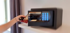 A hand inserting a passport into a wall-mounted biometric device. - Family interconnected suite (BERGAMO)