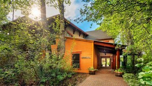 A wooden building with a brick pathway leading to a door. - Basecamp Stays: Upscale Couple's Getaway, Hot Tubs (Driggs)