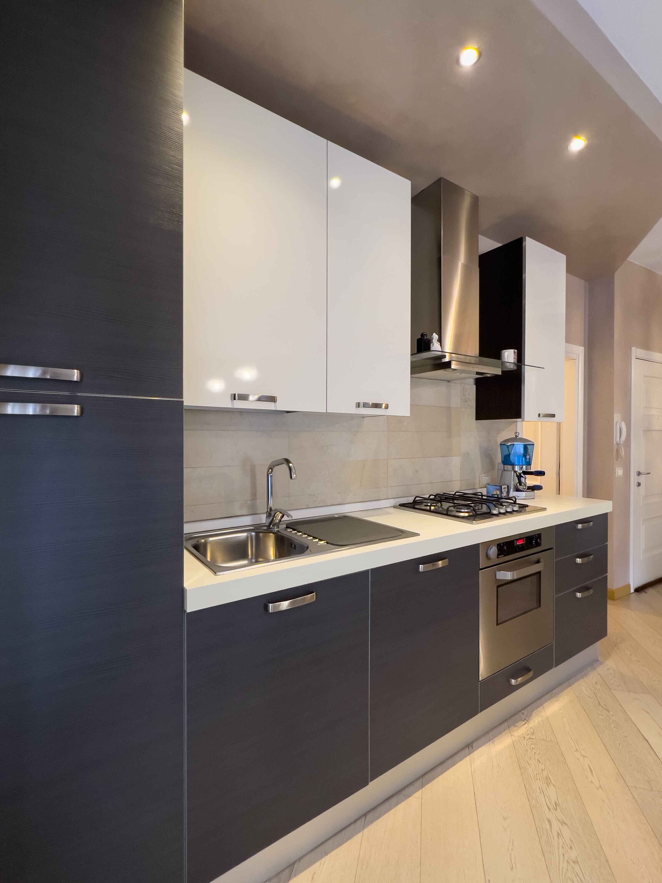 Fridge, stovetop, dishwasher, coffee/tea maker