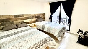 A bedroom with two beds, a wooden headboard, a window with curtains, and a view outside. - Depa Lunero, 5 minutes walking from the beach! (Cancún)