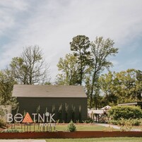 A small, single-story motel with a dark exterior and a sign that reads "BeTNIK MOTEL".