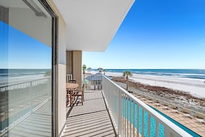 Un balcón con vista a la playa y al océano.