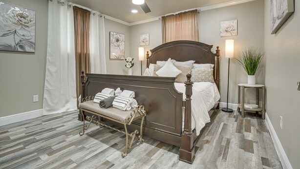 A bedroom with a bed, a bench, a floor lamp, and a ceiling fan. - Deck, Yard & Outdoor Dining: Destrehan Getaway! (Destrehan)