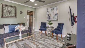 A living room with a sofa, two armchairs, a coffee table, and a TV. - Deck, Yard & Outdoor Dining: Destrehan Getaway! (Destrehan)
