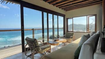 Villa Deluxe, vista al océano | Área de sala de estar