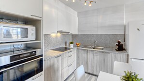 A modern kitchen with granite countertops, stainless steel appliances, and a built-in oven. - Onada I by Interhome (Empuriabrava)