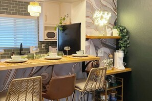 Fridge, dishwasher, coffee/tea maker, cookware/dishes/utensils