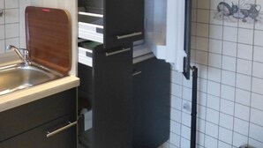 A kitchen with a microwave, a sink, and a refrigerator.