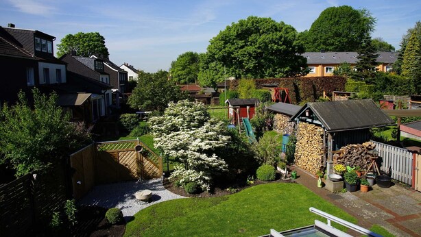A residential area with houses, a garden, and a small shed.