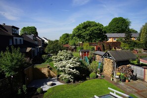 Un quartier résidentiel avec des maisons, un jardin et un petit abri de jardin.