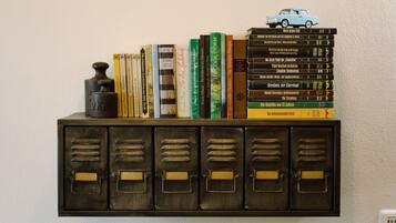 A bookshelf with books and a toy car.