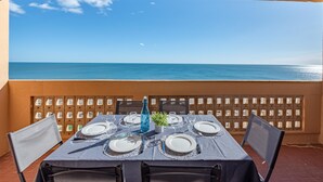 A table set for four with a view of the sea.