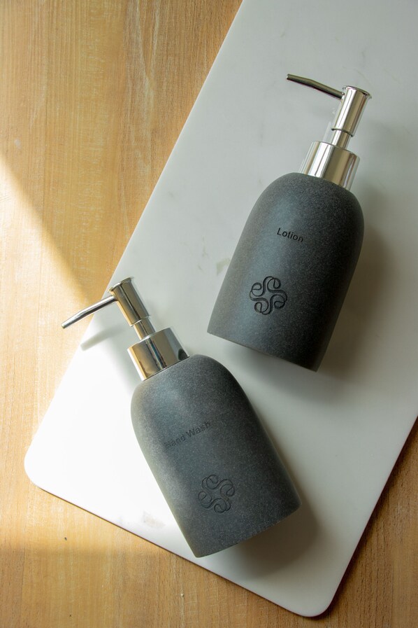 Two gray bottles with pumps on a white surface. - Stone Hotel Dhiffushi (Dhiffushi)