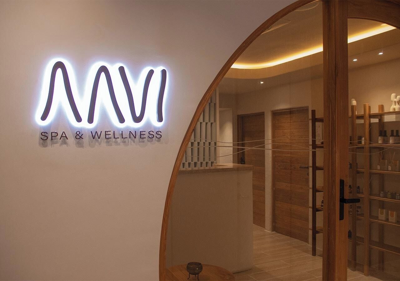 A spa and wellness center with a modern interior, a reception desk, and a wooden reception area.