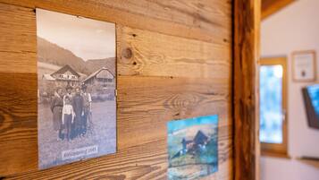 A wooden wall with two framed photographs, one labeled 'Kreuzplonhof 1945'.