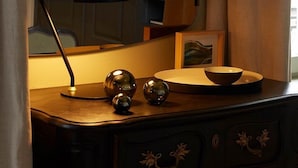 Un bureau avec une lampe, un miroir et des objets décoratifs.