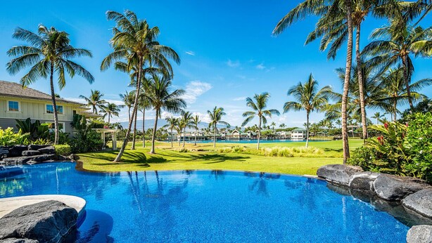 A swimming pool with clear blue water, surrounded by palm trees and a well-maintained lawn. - 🏖️Top-Floor Waikoloa Condo Overlooking Golf Course | Walk to A-Bay & Shops | Fairway Villas A31 (Waikoloa)