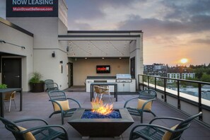 Relax in style with a fire pit and comfortable seating, overlooking the city.