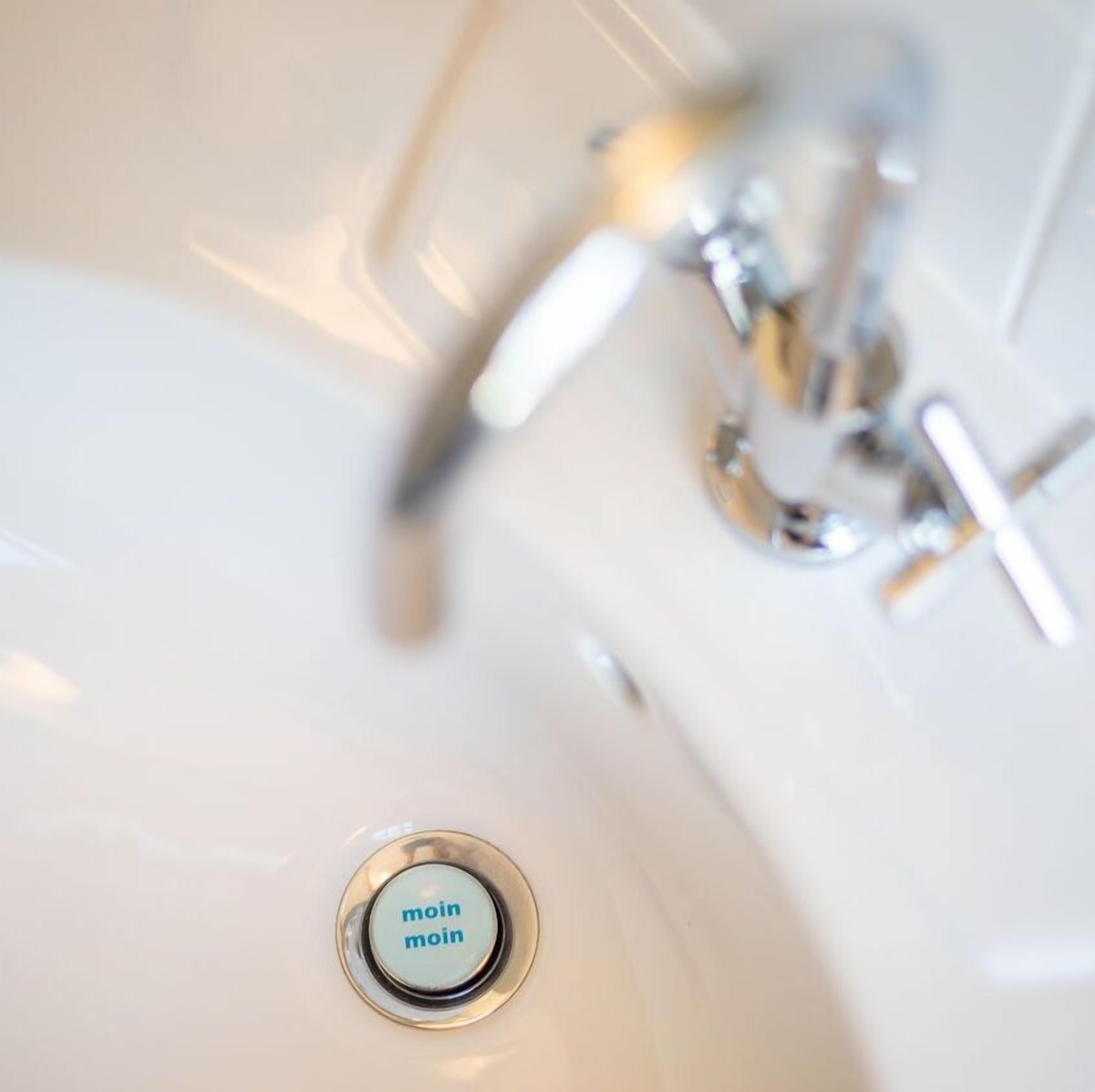 A bathroom sink with a "main" label on the drain.