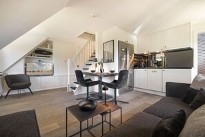Un appartamento moderno con zona pranzo, cucina e soggiorno.