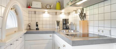 Fridge, stovetop, dishwasher, coffee/tea maker