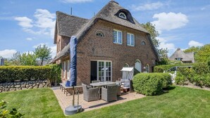 A large brick house with a steeply pitched roof and a chimney. - Litz Hüs - Litz Hüs - Reetgedeckte Wohnung Liegt Idyllisch im Süden von Keitum (Sylt / OT Keitum)