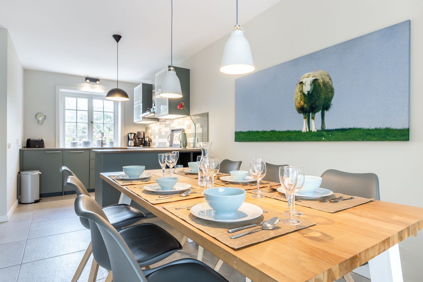 A modern kitchen with a dining area set for six.