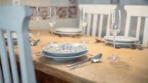 A dining table set with plates, glasses, and cutlery.