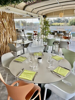 Dine al fresco amidst lush greenery and a serene pool view.