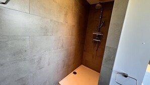 A modern shower area with a glass door, a showerhead, and a control panel. - Lovely House in Heers With 2 Bedrooms (Heers)