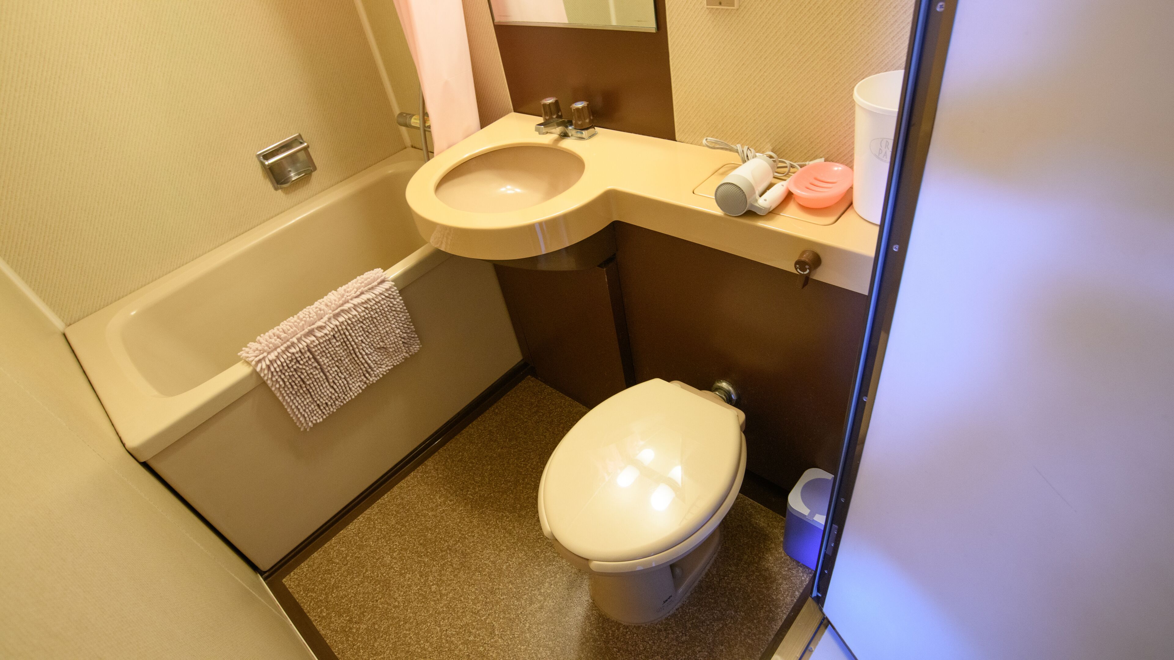 A small bathroom with a bathtub, sink, and toilet.