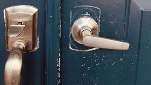 A door with a key lock, a numeric keypad, and a door handle.